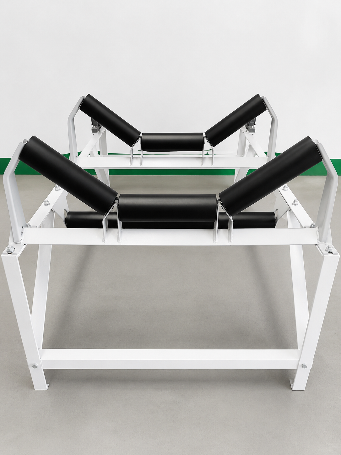 Conveyor trough idler set on white frame