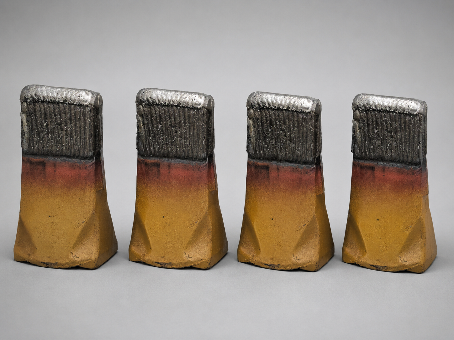 Yellow hardfaced bucket teeth row